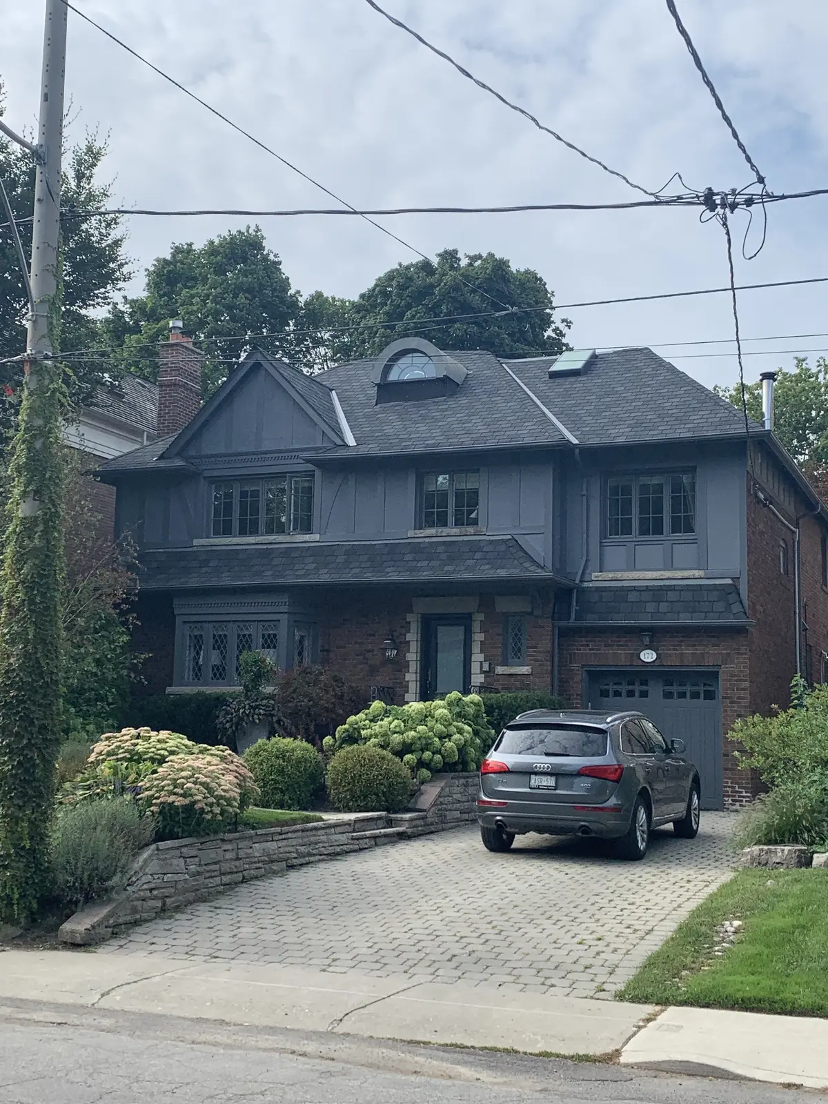 Grey two-storey home with a dark asphalt shingle roof: asphalt shingle roofing by Eagle Roofing