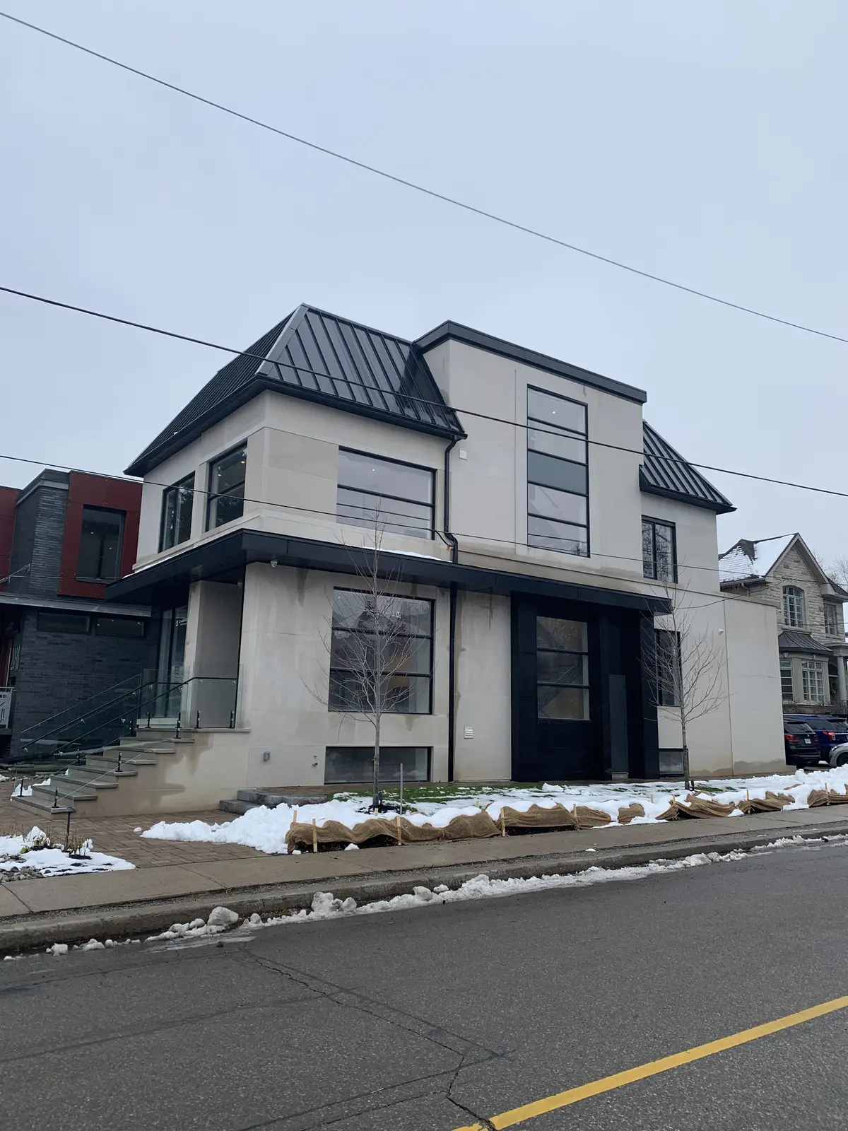 Modern home with a black metal roof: metal roofing by Eagle Roofing